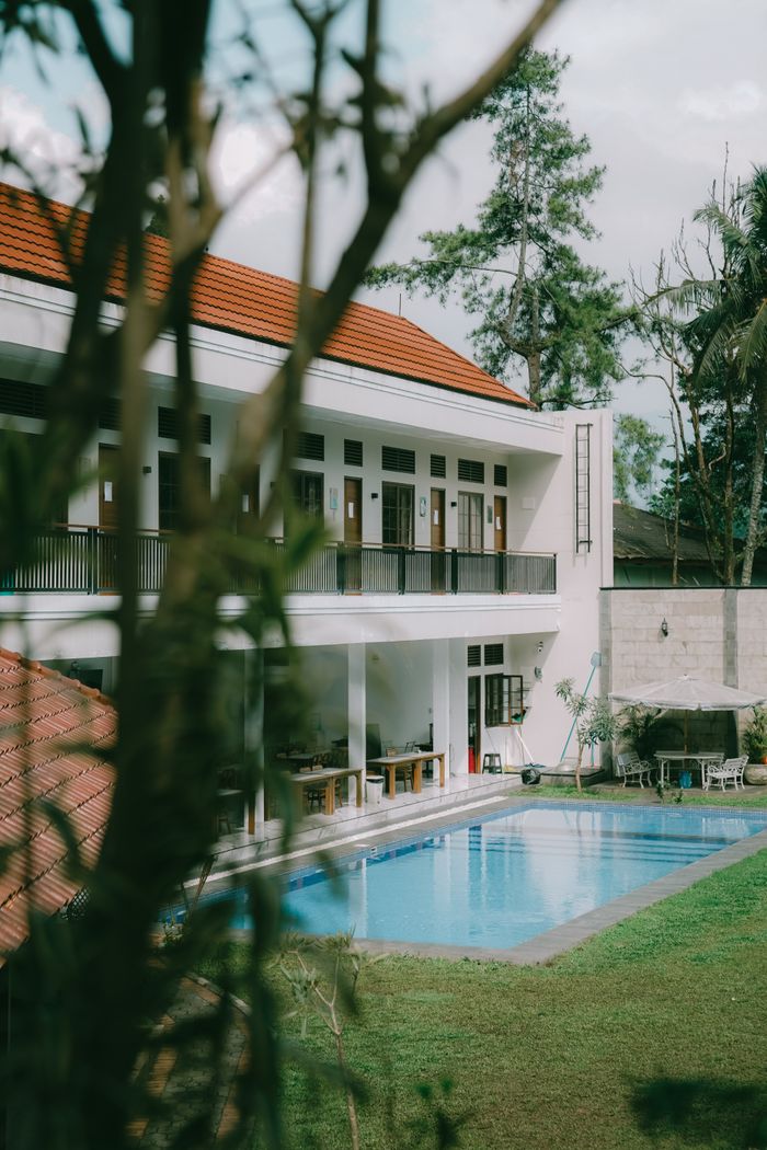 Stunning villa in Cisarua, West Java featuring a serene pool and lush surroundings.